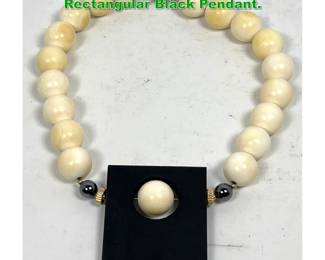 Lot 1325 Ivory Bead Necklace with Rectangular Black Pendant. 