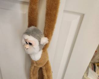 Several 'hanging' monkeys and other stuffed animals. 
