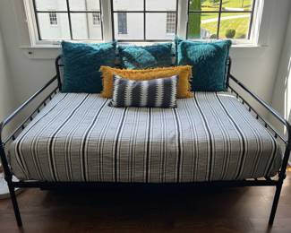 Full size iron bed with rolling trundle underneath