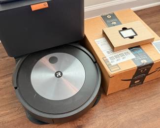 iRobot Roomba j7+ self-emptying robot vacuum with box of unopened accessories