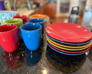 Set of colorful plates and mugs