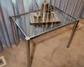 Glass top side table. Stainless steel coffee set.