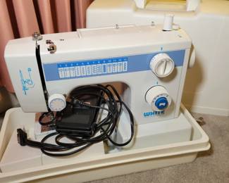 White portable sewing machine.
