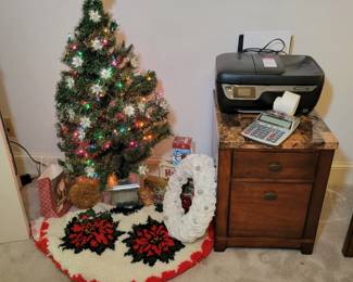 Small artificial Christmas tree. Marble top office storage.