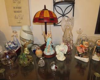 Tables of angels, glass hearts and eggs, Hummels, paperweights.