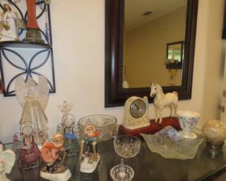 Tables of angels, glass hearts and eggs, Hummels, paperweights.