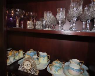 Shelves of porcelain, lead crystal, vintage stemware,