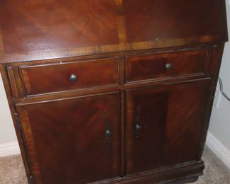 Drop down writing desk with drawers and cabinets.