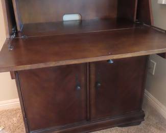 Drop down writing desk with drawers and cabinets.