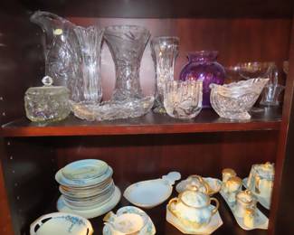 Shelves of porcelain, lead crystal, vintage stemware,
