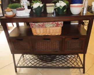 Entry table with basket storage and shelves.