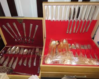 Two sets of silver plate flatware.
