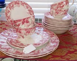 Strawberry Fair" dinnerware by Johnson Brothers. 
This pattern features pink/red strawberries, flowers, and leaves on a cream-colored background. 