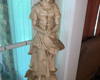 Large plaster statue on a pedestal of biblical figure Ruth or a gleaner