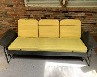 black metal glider with yellow cushions