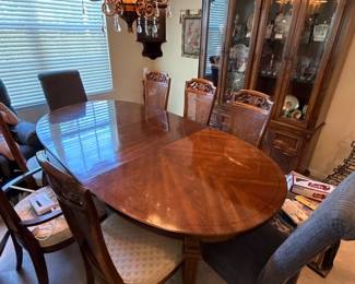 cherry wood oval dining table with 6 cane back chairs