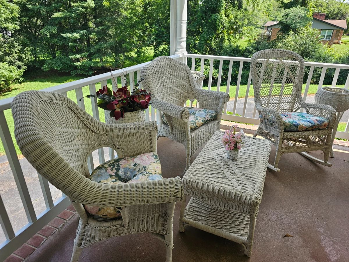 Beautiful white wicker chairs, tables, planters, settee, and rockers