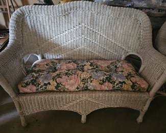 Wicker settee and several other pieces with cushions