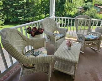 Beautiful white wicker chairs, tables, planters, settee, and rockers