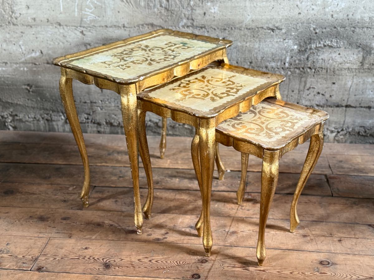 This lot features a set of three (3) vintage Italian florentine nesting tables circa 1950s. The largest table measures, 23” H x 22.5” W x 14.5” D. Minor wear throughout as shown in photos.