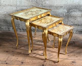 This lot features a set of three (3) vintage Italian florentine nesting tables circa 1950s. The largest table measures, 23” H x 22.5” W x 14.5” D. Minor wear throughout as shown in photos.