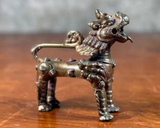 This lot features a vintage Chinese brass Foo Dog in excellent condition with wonderful detail. This item measures, 4.5” H x 5” W x 2.5” D. Foo dogs are symbolic, protective statues, and they are designed in pairs — one is female, the other is male. The female represents yin, and symbolically protects the people dwelling inside the home, while the male statue, representing yang, protects the structure itself.
