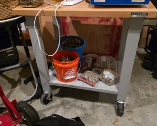 Work table on wheels.   More empty shell casings for loading.