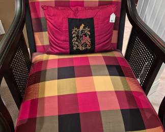 Nice wicker chair with comfy cushions.