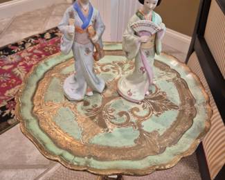 Small round table with a pair ofJapanese lady figurines.
