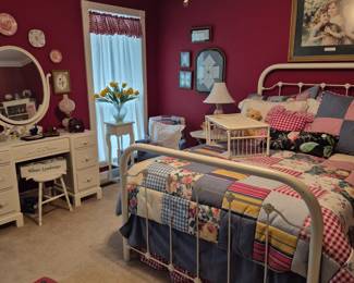 I lLOVE this room! It is both  invit[ng and cozy!   It featuress a full size iron bed. and mattress.  The antique painted Dresserwith the big   round, cheerful mirror is also a wonderful addtion!  
