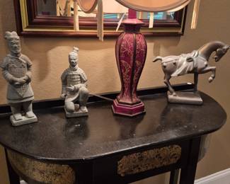 This fine old lacquer finished side table with some gold embelishment holds a Gorgeous tall Oriental lamp and large oriental figurines.