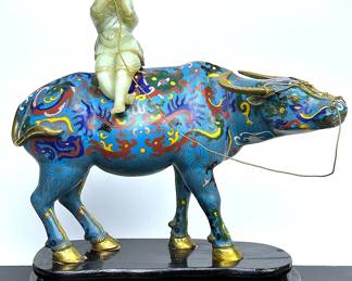 Large Chinese cloisonne water buffalo with heard boy riding on top while playing a flute.  