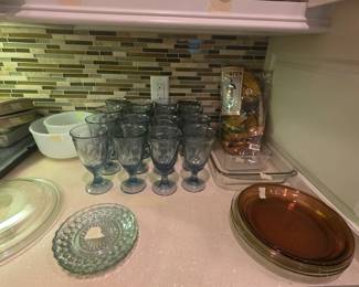 Platters, lids, bowls, glasses set in kitchen
