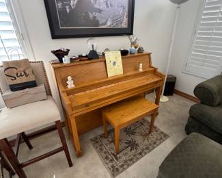Oak upright piano and bench.