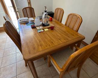 Oak dining table with leaves, 6 cane back chairs. Great scale.