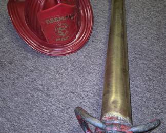 Collectible firefighting items. 30" brass fire hose nozzle and "Fireman's Fund" plastic helmet