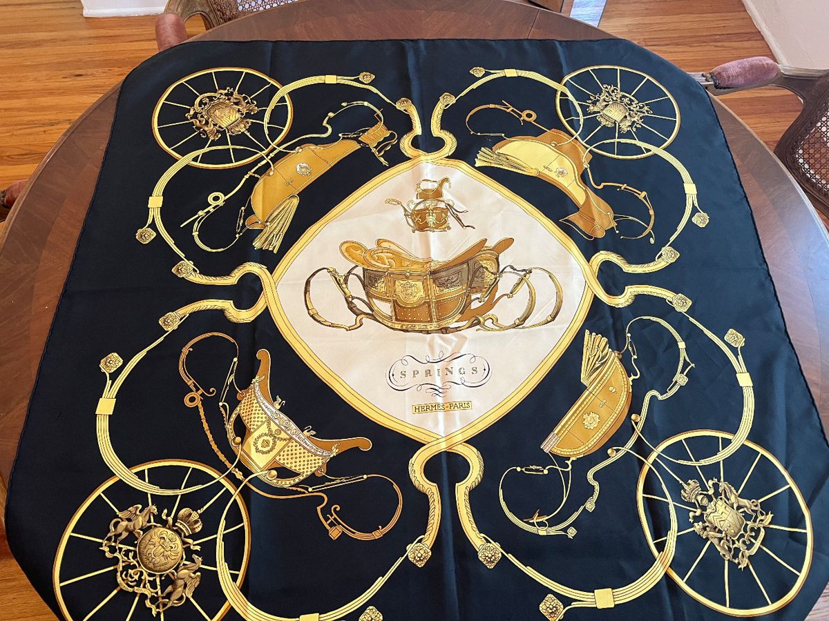 authentic Hermès "Springs" silk scarf, a classic design featuring horse-drawn carriages and equestrian elements
C 1990s
100% silk