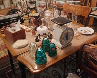 Glass insulators, vintage kitchen scale, porcelain top table