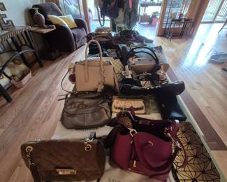 Name brand purses, many with bags.