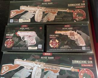 Several ROKR Justice Guard wooden model kits of firearms