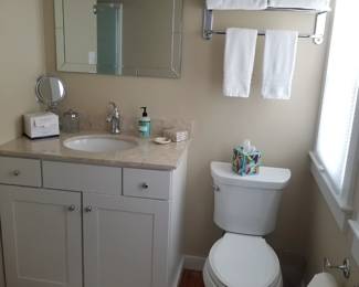 Updated bath vanity; mirror; vanity lights; hotel towel rack