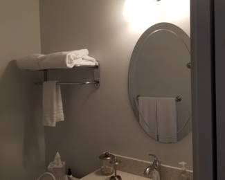 Mirror; vanity light; hotel towel rack