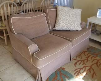 Neutral tan loveseat by Braxton Culler; area rug