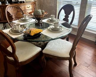 Glass top round dining table with ceramic Asian decor pot as a base