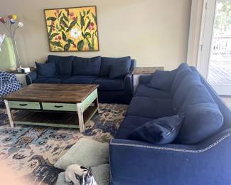 Two slip -covered sofas 87" long by 37" deep. Coffee table 30" x 50"