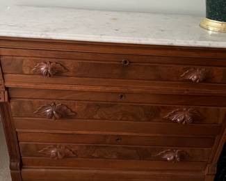 Beautiful walnut chest of drawers with marble top.  This piece has hand carved Acorn pulls that are lovely and give it such character