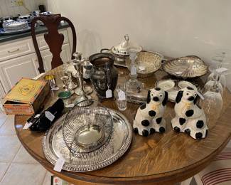 We have a great selection of Silver plated serving pieces, and bread baskets.   Also LOOK at this perfectly sized round oak table with glass topper...beautiful!