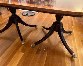 The double pedestal base of this gorgeous dining room table with solid brass clawfeet detail.  This table has two leaves and custom made pads.