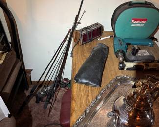 Basement rec room. Fishing poles and silver plate