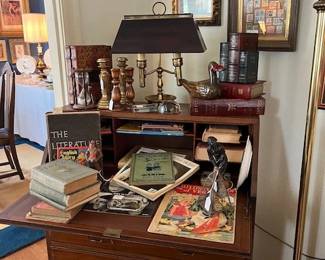 Vintage writing desk, vintage books and magazines, vintage Bouillotte lamp with metal shade